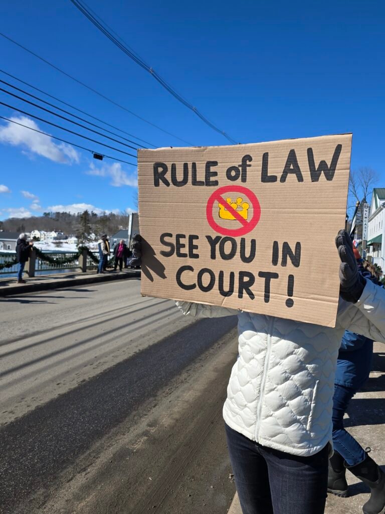 Sign from the Newcastle-Damariscotta bridge in February 2025: Rule of Law, No Crown, No King.  See You In Court!