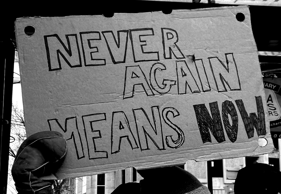 Never Again protest sign